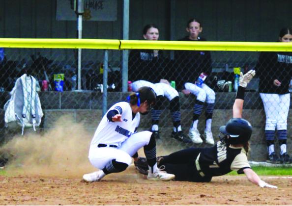 SAFE AT THIRD - Woodlawn third baseman Kathryn Dixon just misse s the tag on Rison's Riley Hyatt as she slides into third base with her triple in the third inning.